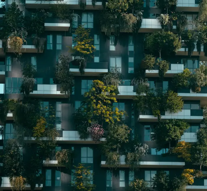 A modern building showcasing vibrant plants on its balconies, blending nature with contemporary architecture.