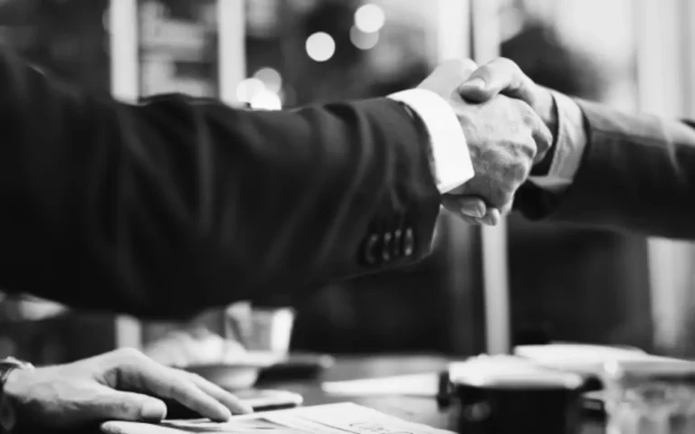 Two business men shaking hands, symbolizing collaboration and professional connections.