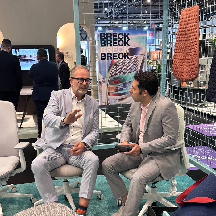 Mahmoud Zohny, CEO of ZF Holding, in conversation with a seated colleague at Index Expo Dubai 2025.